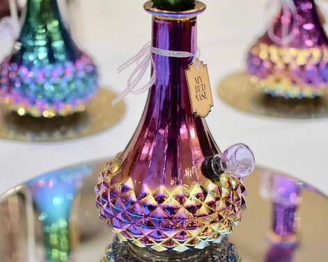 Colorful vase with peacock feather design on a computer screen